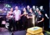 Descubra el refrescante oasis de Awaysis en Puerto Vallarta – Celebrando un Año Celebrating one year, Awaysis staff gather around a cake. Photo by Oscar Almeida.